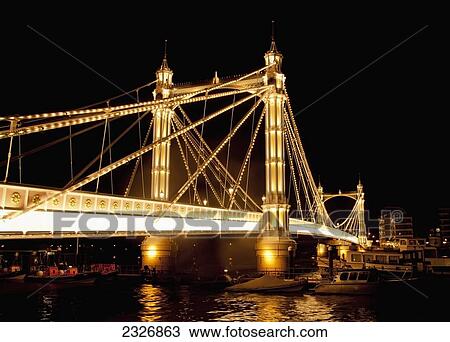 Stock Image - UK, England, Albert Bridge at night; London. Fotosearch