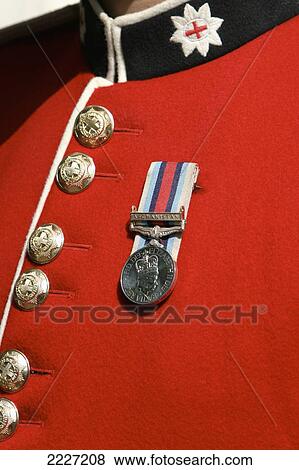 Stock Photo - UK, England, Close up of Soldiers uniform from Queens Household Division guarding Buckingham Palace with medal won in Afghanistan; London. Fotosearch