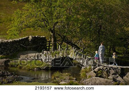UK, England, Cumbria, Mother and children crossing Slaters Bridge near Little Langdale; Lake District National Park View Large Photo Image Stock Photo - UK, England, Cumbria, Mother and children crossing Slaters Bridge near Little Langdale; Lake District National Park. Fotosearch