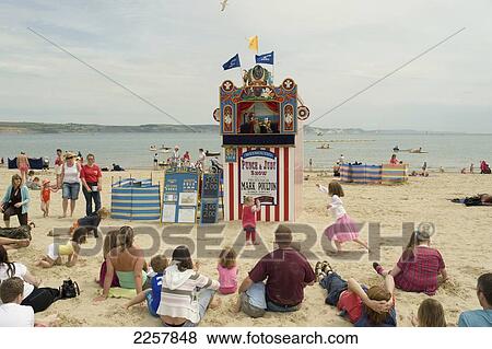 Stock Photo - Uk, England, Dorset, West Dorset, Punch And Judy On Beach; Weymouth. Fotosearch