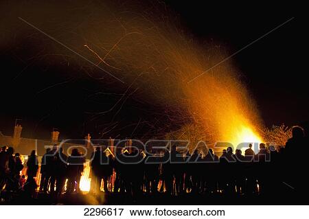 Stock Photo - UK, England, East Sussex, People in front of large bonfire at Newick Bonfire night; Newick. Fotosearch