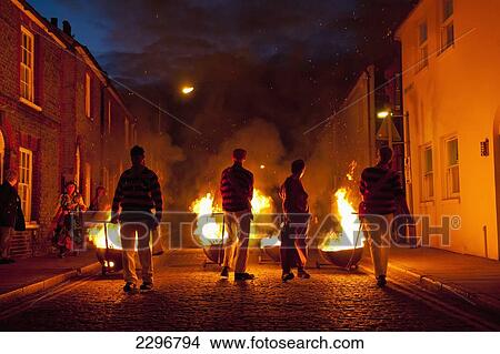 Picture - UK, England, East Sussex, People dressed as smugglers carrying burning carts down street; Lewes. Fotosearch