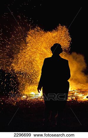 UK, England, East Sussex, Silhouettes of man wearing bowler hat in front of bonfire at Newick Bonfire night; Newick View Large Photo Image Stock Photo - UK, England, East Sussex, Silhouettes of man wearing bowler hat in front of bonfire at Newick Bonfire night; Newick. Fotosearch