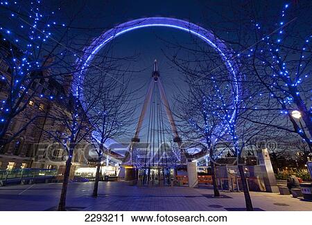 Stock Image - UK, England, London Eye spinning at dusk; London. Fotosearch