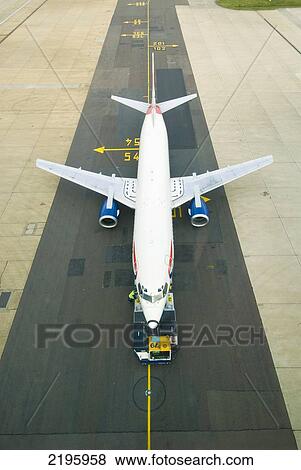 Stock Photo - UK, England, Looking down on plane preparing to depart on runway at Gatwick Airport; London. Fotosearch