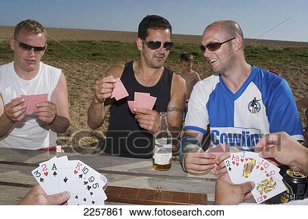 Uk, England, Man Playing Cards In Freshwater Beach Holiday Park On Jurassic Coast; Dorset View Large Photo Image Stock Image - Uk, England, Man Playing Cards In Freshwater Beach Holiday Park On Jurassic Coast; Dorset. Fotosearch