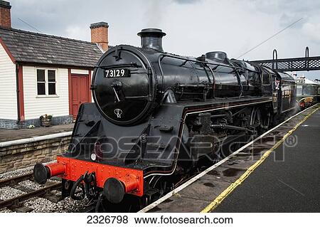 Stock Photo - UK, England, Midland Railway; Derbyshire, Steam train arriving at Swanwick Junction. Fotosearch