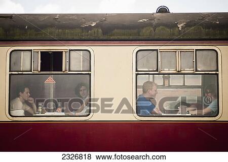 UK, England, Midland Railway; Derbyshire, Festival goers having coffee inside train at Indietracks Festival View Large Photo Image Stock Photo - UK, England, Midland Railway; Derbyshire, Festival goers having coffee inside train at Indietracks Festival. Fotosearch