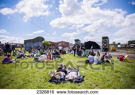 Stock Photograph - UK, England, Midland Railway; Derbyshire, Festival goers relaxing at Indietracks Festival. Fotosearch