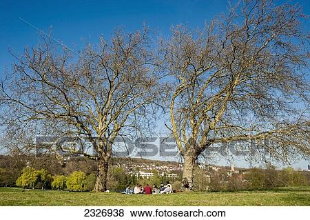 Stock Photo - UK, England, North London; London, People enjoying the sun in Primrose Hill in Hampstead. Fotosearch