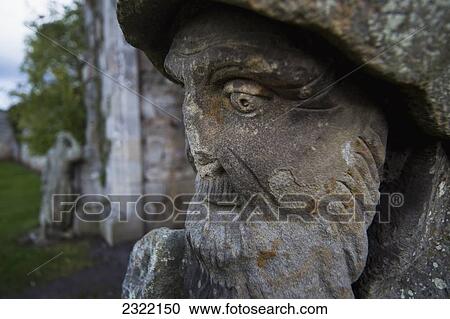 Stock Image - UK, England, Northumberland, Alnwick, Hume Park, Close-up of sculpture of bearded man. Fotosearch