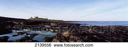 Uk, England, Northumberland, Near Craster; Northumbrian Coast, Panoramic View Of Dunstanburgh Castle View Large Photo Image Stock Photograph - Uk, England, Northumberland, Near Craster; Northumbrian Coast, Panoramic View Of Dunstanburgh Castle. Fotosearch