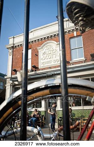 Stock Photo - UK, England, People enjoying sunny day near Broadway Market in Shoreditch; London. Fotosearch