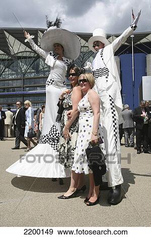 Stock Photo - Uk, England, Performers On Stilts At Entrance To Grand Enclosure During Royal Ascot Horse Racing Meeting; Berkshire. Fotosearch