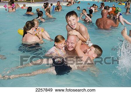 Uk, England, Portrait Of Family In Swimming Pool In Freshwater Beach Holiday Park On Jurassic Coast; Dorset View Large Photo Image Stock Photo - Uk, England, Portrait Of Family In Swimming Pool In Freshwater Beach Holiday Park On Jurassic Coast; Dorset. Fotosearch