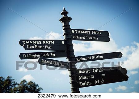 Stock Photo - UK, England, Richmond; London, Richmond Park, Directions sign in Thames riverside. Fotosearch