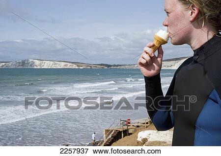 Uk, England, Scenic View Of Brook Bay With Woman Eating Ice-Cream In Foreground; Isle Of Wight View Large Photo Image Stock Photo - Uk, England, Scenic View Of Brook Bay With Woman Eating Ice-Cream In Foreground; Isle Of Wight. Fotosearch