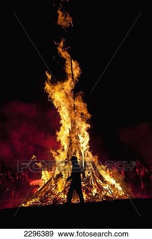 UK, England, Silhouette of man walking past large bonfire at Battle Bonfire night; East Sussex View Large Photo Image Stock Photo - UK, England, Silhouette of man walking past large bonfire at Battle Bonfire night; East Sussex. Fotosearch