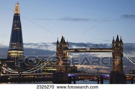 Stock Image - UK, England, The Shard and Tower Bridge on River Thames at dusk; London. Fotosearch