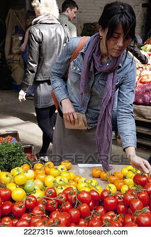 Stock Photography - UK, England, Young woman shopping at Borough Market; London. Fotosearch
