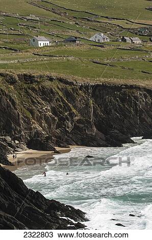 Stock Image - UK, Ireland, County Kerry, Dingle, Surfers at Coumeenoole. Fotosearch