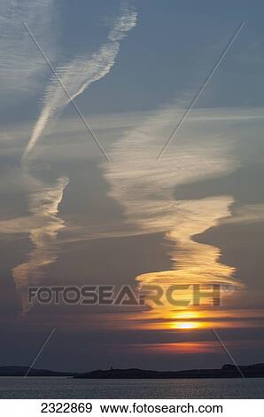 Stock Photo - UK, Ireland, County Kerry, Iveragh Peninsula, Cahersiveen, Sunset at Reenard Point looking across to Valentia Island. Fotosearch