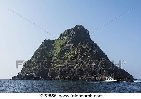 Stock Photograph - UK, Ireland, County Kerry, Skellig Islands, Skellig Michael and tourist boat. Fotosearch
