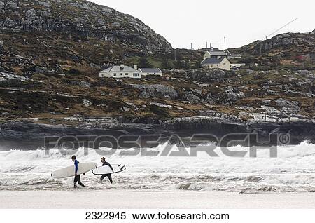 Stock Photography - UK, Ireland, County Kerry, Surfers in Derrynane Bay. Fotosearch