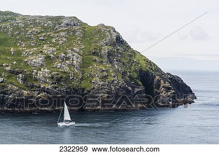 Stock Photo - UK, Ireland, County Kerry, Yacht sailing into Dursley Sound. Fotosearch
