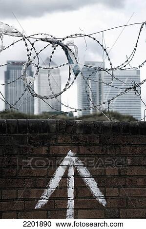 UK, London, Canary Wharf in background; Greenwich Pennisula, plastic bags caught on barbs, Brick wall with barbed wire on top View Large Photo Image Stock Image - UK, London, Canary Wharf in background; Greenwich Pennisula, plastic bags caught on barbs, Brick wall with barbed wire on top. Fotosearch