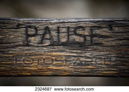 Stock Photo - UK, London, Detail of word pause carved in wooden bench in Richmond Hill; Richmond. Fotosearch