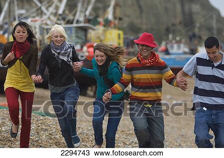 Stock Image - UK, Mixed group of teenagers at seaside; Hastings. Fotosearch