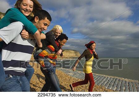Stock Photography - UK, Mixed group of teenagers at seaside; Hastings. Fotosearch