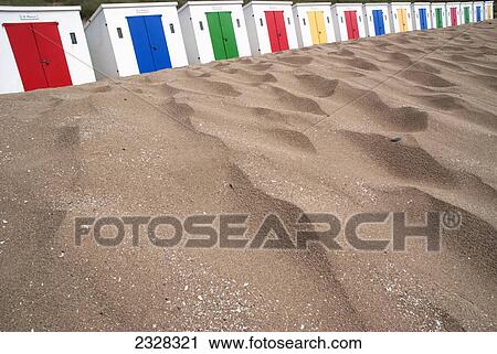 Stock Image - UK, North Devon, Beach huts with colorful doors; Woolacombe. Fotosearch