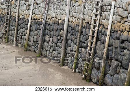 UK, North Devon, Wooden ladders and pillars at harbor during low tide; Clovelly View Large Photo Image Stock Photography - UK, North Devon, Wooden ladders and pillars at harbor during low tide; Clovelly. Fotosearch