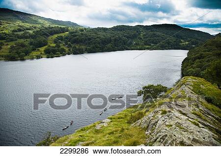 UK, North Wales, Snowdonia National Park, Nantgwynant, glistening in the sunlight. view over the lake from a rocky outcrop; Llyn Gwynant Campsite, Lake Nant Gwynant View Large Photo Image Stock Photograph - UK, North Wales, Snowdonia National Park, Nantgwynant, glistening in the sunlight. view over the lake from a rocky outcrop; Llyn Gwynant Campsite, Lake Nant Gwynant. Fotosearch