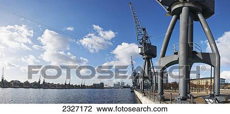 Stock Image - UK, Panoramic view looking towards Canary Wharf from old crane at side of Royal Victoria Docks; London. Fotosearch