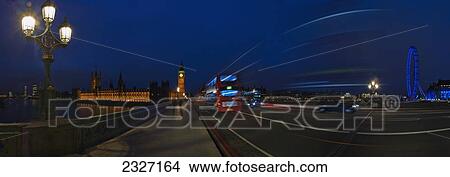 Picture - UK, Panoramic view of Westminster Bridge with traffic at night with Houses of Parliament and London eye in background; London. Fotosearch