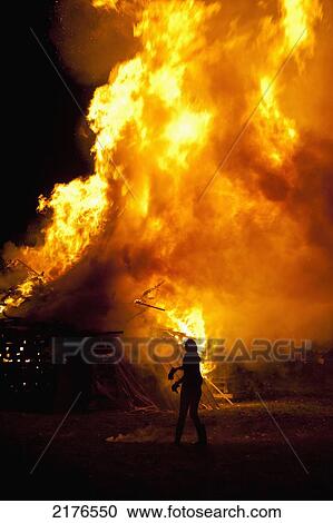 UK, Person throwing burning torch onto large bonfire at Barcombe Bonfire Night; East Sussex View Large Photo Image Stock Image - UK, Person throwing burning torch onto large bonfire at Barcombe Bonfire Night; East Sussex. Fotosearch