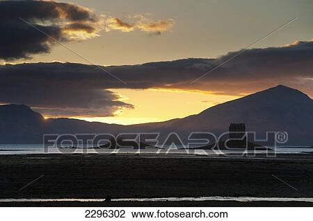 Stock Image - UK, Scotland, Argyll and Bute, Castle Stalker at dusk; Appin. Fotosearch