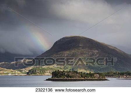 Stock Photograph - UK, Scotland, Highlands, Applecross Peninsula, Landscape with rainbow and storm clouds. Fotosearch