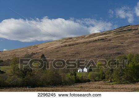 Stock Photography - UK, Scotland, Large white house beneath hills near Appin; Argyll and Bute. Fotosearch