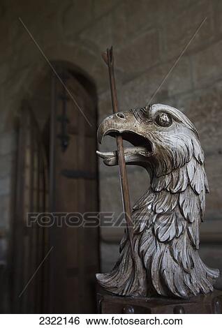 Stock Photograph - UK, Scotland, Scottish Borders, Yetholm, Sculpture of eagle with sceptre in it's mouth. Fotosearch