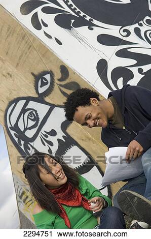 UK, Teenage girl and boy studying in front of graffiti wall; Hastings View Large Photo Image Stock Image - UK, Teenage girl and boy studying in front of graffiti wall; Hastings. Fotosearch