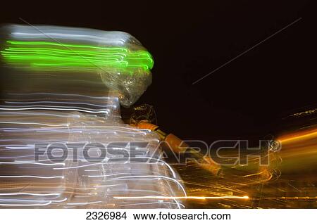 Picture - UK, Thames Festival Parade; London, Silver giant mechanical skeleton with green eyes. Fotosearch
