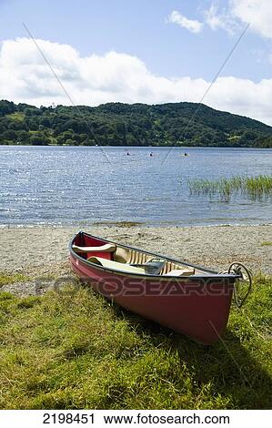 Stock Image - UK, Wales, North Wales, Snowdonia National Park, Canoe by Nant Gwynant Lake near Llyn Gwynant Campsite; Nant Gwynant. Fotosearch