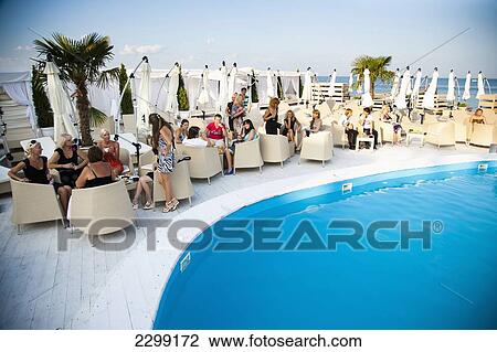 Stock Image - Ukraine, swinging nightlife; Odessa, Poolside at High class night club on beach. Fotosearch