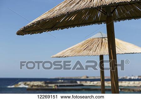 Umbrellas at the water's edge; Paphos, Cyprus View Large Photo Image Stock Image - Umbrellas at the water's edge; Paphos, Cyprus. Fotosearch