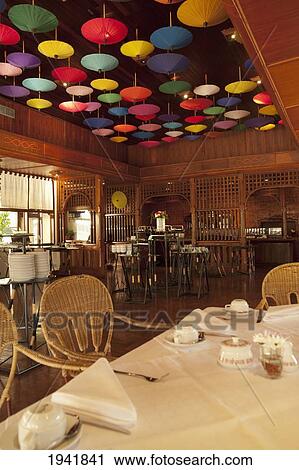 Stock Image - Umbrellas Hanging From The Ceiling At The Restaurant In Amari Rincome Hotel; Chiang Mai Thailand. Fotosearch