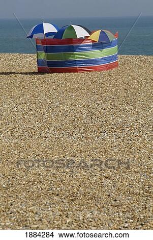 Picture - Umbrellas On Pebble Beach, Hastings. Fotosearch